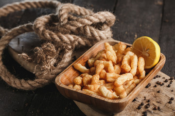 Tasty cheese fries on wooden table