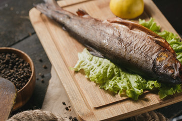 Fried fish on plate with vegetables