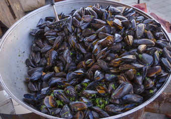 Boiled mussels in a copper cup.