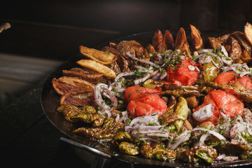 Grilled meat and vegetables on rustic wooden table