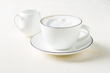 Italian homemade espresso coffee in a white mug. Light background.