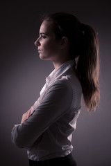 Corporate portrait of business woman over dark gray background