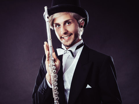 Elegantly dressed musician holding flute