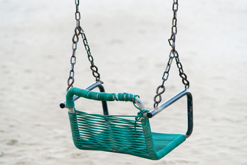 green plastic swing