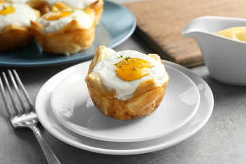 Tasty baked egg in dough on plate