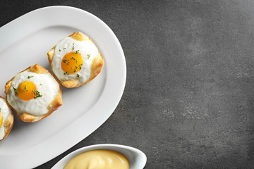 Tasty baked eggs in dough on plate