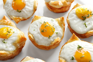 Tasty baked eggs in dough, closeup