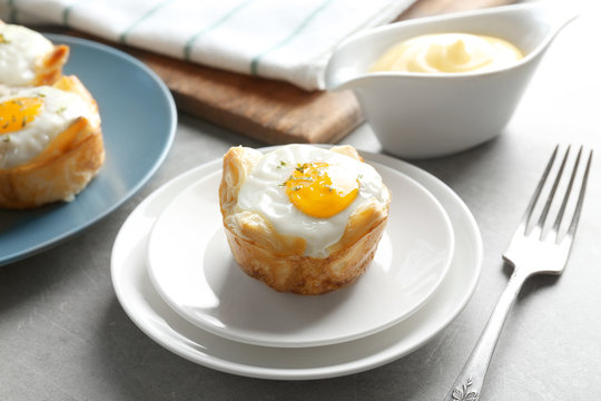 Tasty baked egg in dough on plate