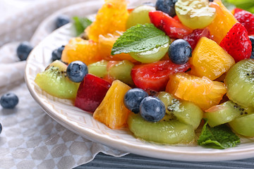 Plate with delicious fruit salad, closeup