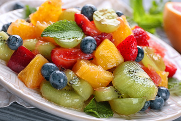 Plate with delicious fruit salad, closeup
