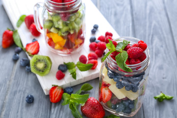 Jar with fruits and berries on table