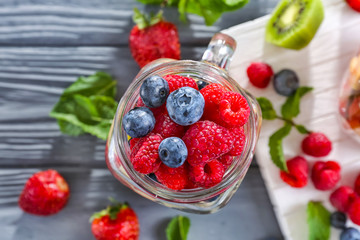 Mason jar with berries on table