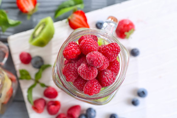 Mason jar with berries on table