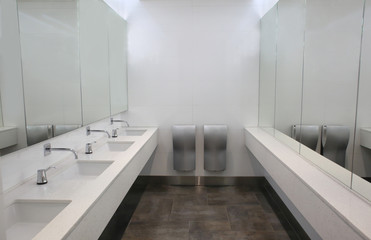 Fototapeta na wymiar Modern sinks with mirrors in public toilet