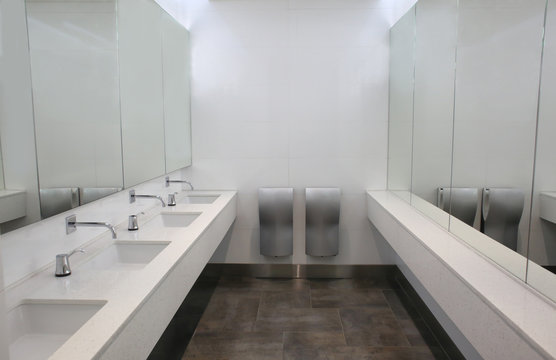 Modern sinks with mirrors in public toilet