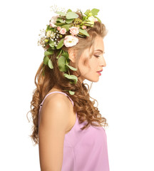 Naklejka premium Beautiful young woman with flower wreath on white background