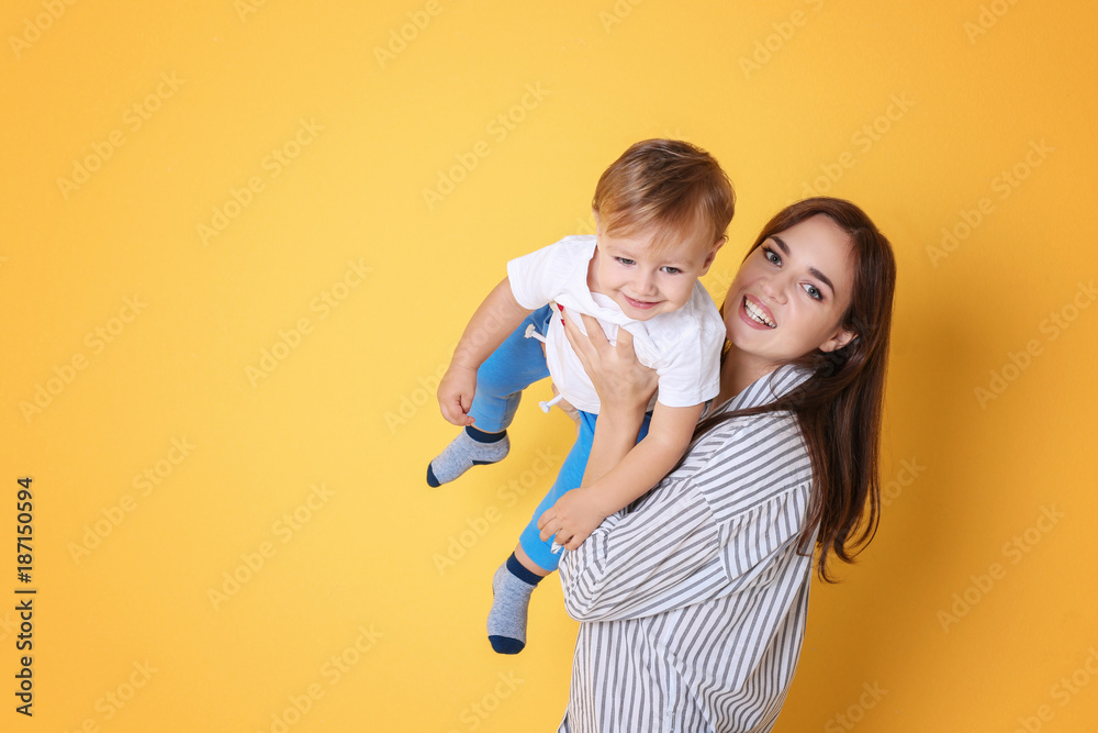 Poster beautiful young woman with her baby on color background