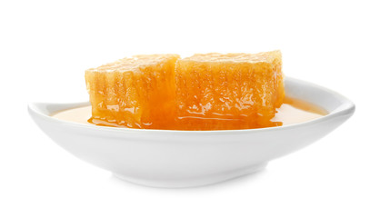 Bowl with fresh honeycombs on white background