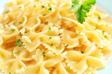 Delicious pasta with garlic and parsley on plate, closeup