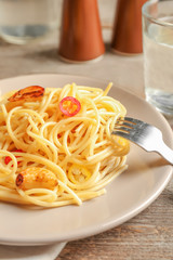 Fototapeta premium Delicious pasta with garlic and chili pepper on plate