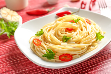 Delicious pasta with garlic and chili pepper on plate