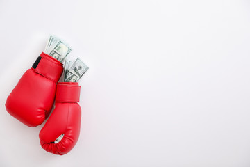 Boxing gloves with money on white background