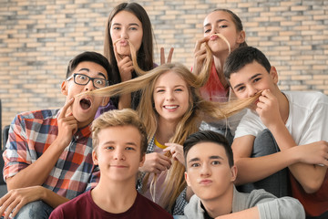 Group of funny teenagers indoors
