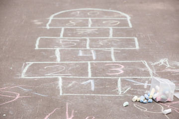 hopscotch drawn on the asphalt with colorful chalk. School yard.