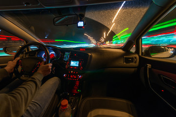 Movement of the car at night at a speed view from the interior, Brilliant road with lights with a car at high speed