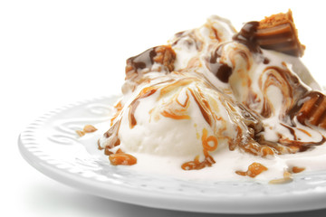 Plate with ice cream and caramel sauce on white background