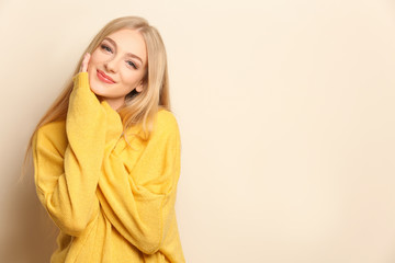 Young beautiful smiling woman on light background