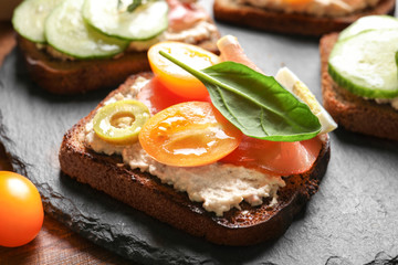 Tasty fresh bruschetta on slate plate, closeup