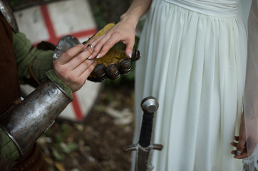 The knight makes an offer to the bride. The ring on bride's finger