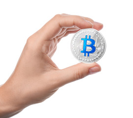 Female hand holding silver bitcoin on white background