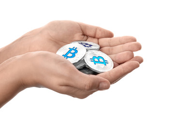 Female hands holding silver bitcoins on white background