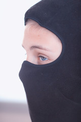 Teenager in a black mask