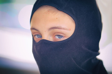 Teenager in a black mask