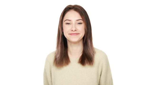 Portrait of brunette lady with narrow eyes having good mood being positive and smiling over white background closeup. Concept of emotions