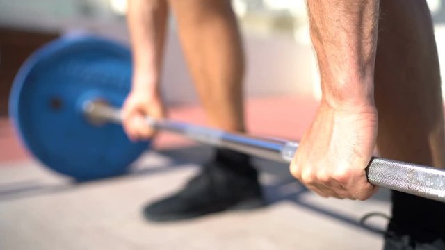 Weightlifting deadlift deadlift exercise. Fitness man bodybuilding or powerlifting at outdoor gym. Close up of hands.