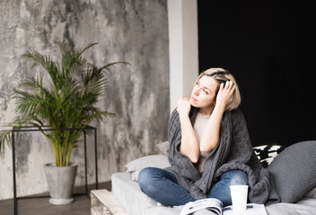 Obraz premium young woman enjoying leisure at home, reading a magazine in bed, cosy home happy and thoughtful emotions