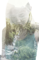Portrait of a young woman with the effect of double exposure. Combination of a picture of nature and a young woman.