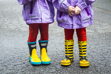 children in rubber boots. Wet, after children's pranks.