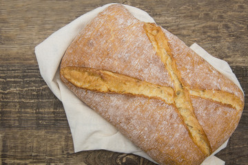 white, fresh bread of the Italian recipe on a wooden table. There is space for text