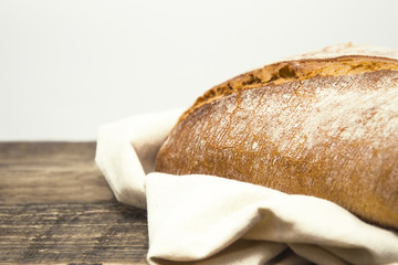 Home made ciabatta,white, fresh bread of the Italian recipe on a wooden table. There is space for text