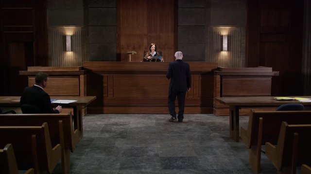 Lawyers in a modern court room arguing a legal case in a judiciary battle in front of a judge