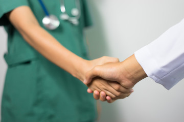 Surgeon medical people handshaking.Doctors and nurses in a medical team stacking handsCross processing and blue tone color