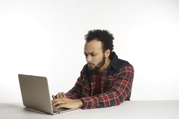 young African-American man on laptop computer with emotions
