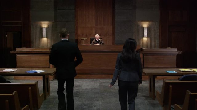 Lawyers in a modern court room arguing a legal case in a judiciary battle in front of a judge