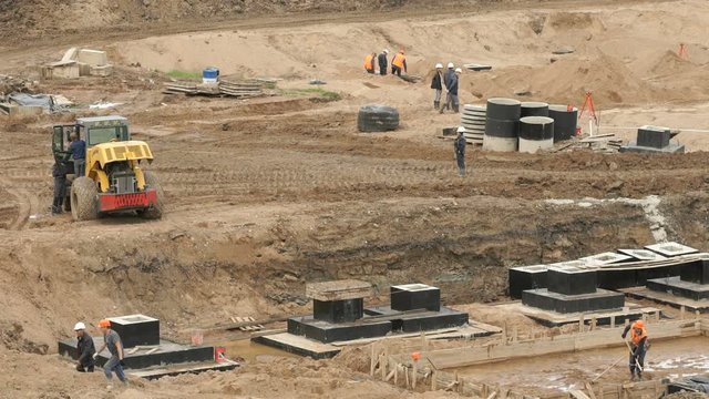 Building large complex and laying the foundation. Brigade of builders at the construction site in a summer season