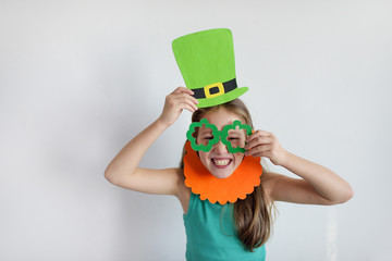 The lovely girl in a mask of a leprechaun for a St. Patrick's Day